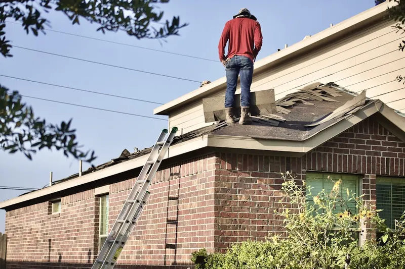 Professional roofer working on a residential roof in West Longview